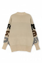 Beige sweater with patterned sleeves on a white background