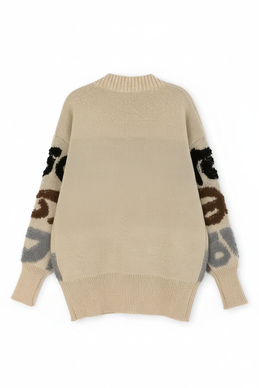 Beige sweater with patterned sleeves on a white background