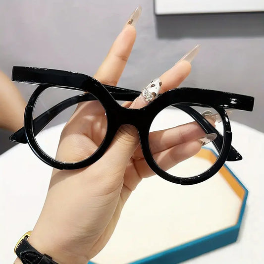 Hand holding a black eyeglasses frame against a neutral background