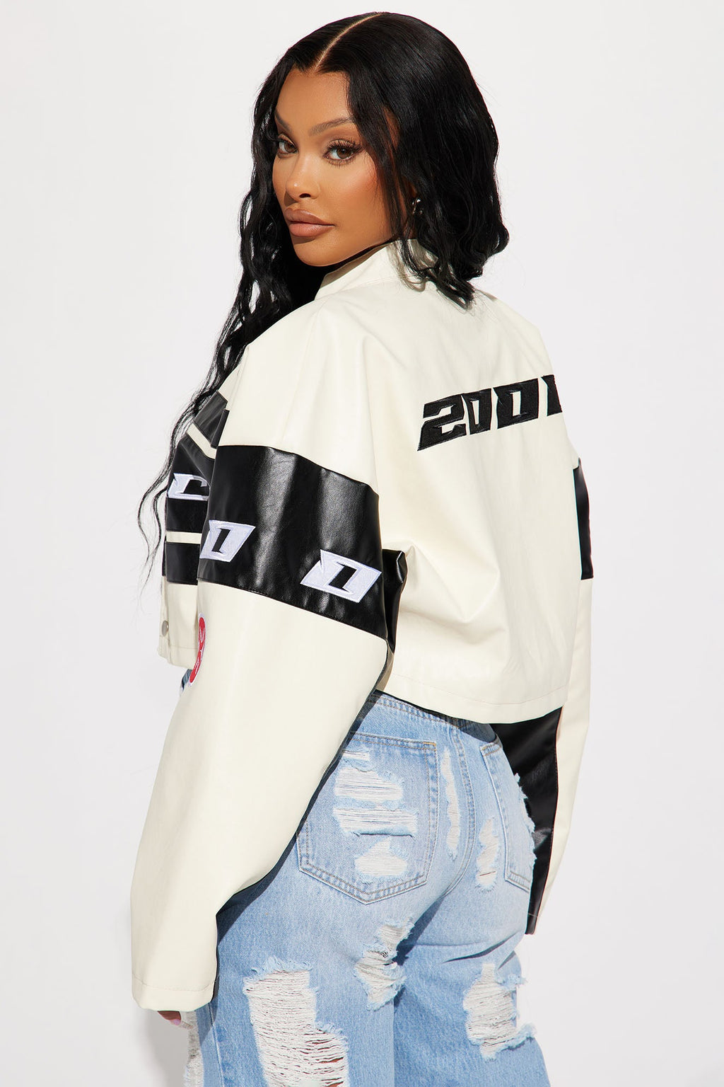 Person wearing a white and black jacket with '21' logo on a white background
