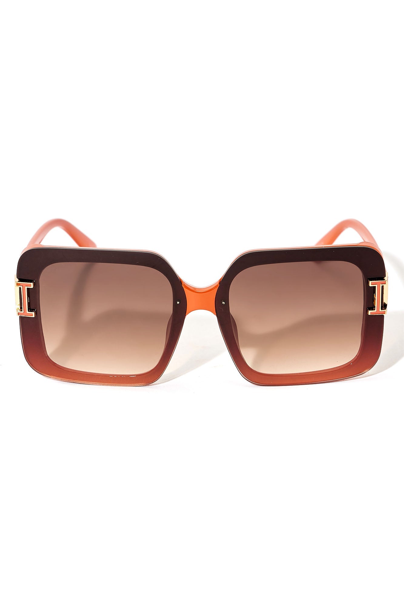 Sunglasses with brown gradient lenses and orange frame on a white background