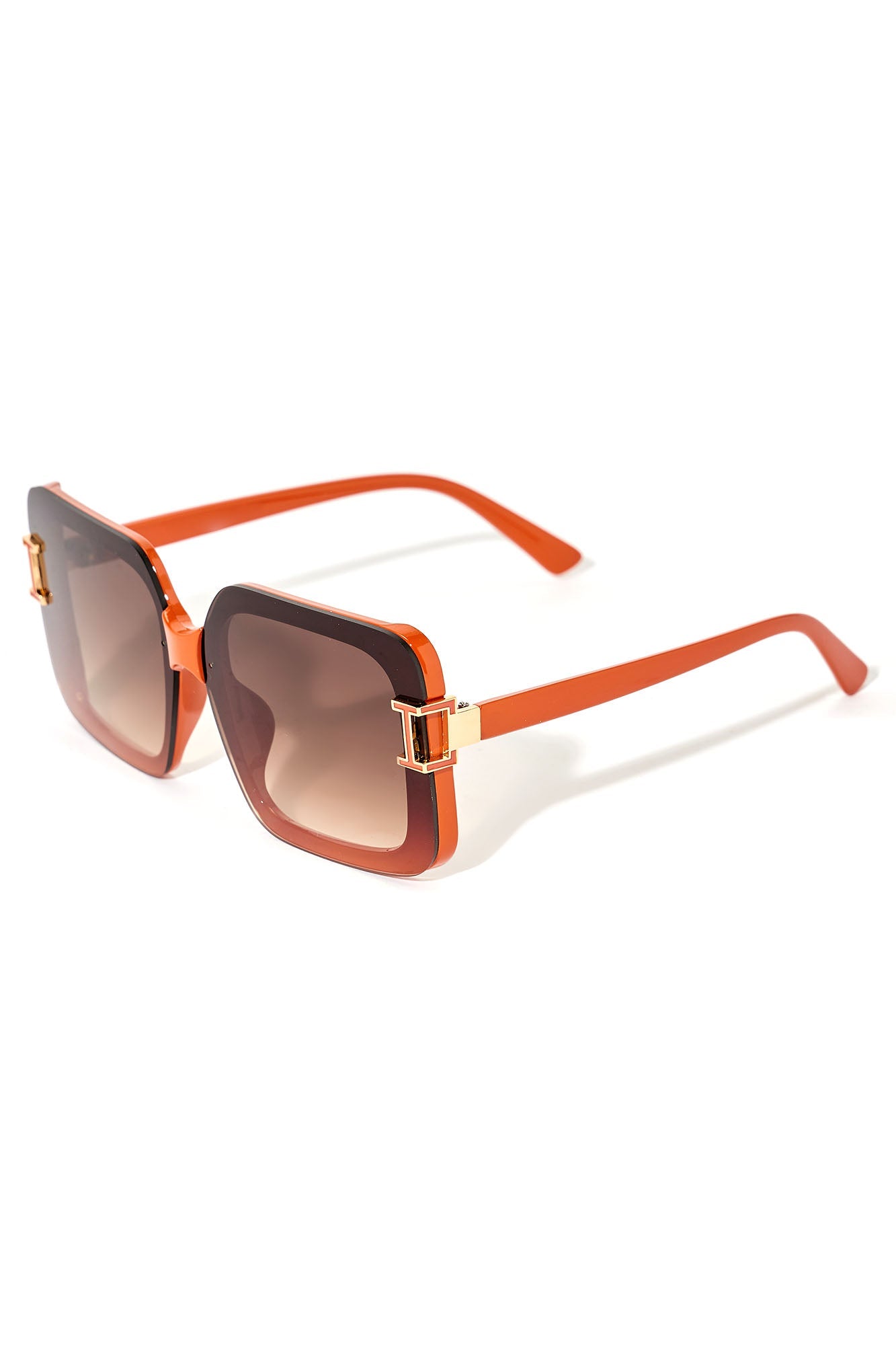 Sunglasses with orange frame and gradient lenses on a white background