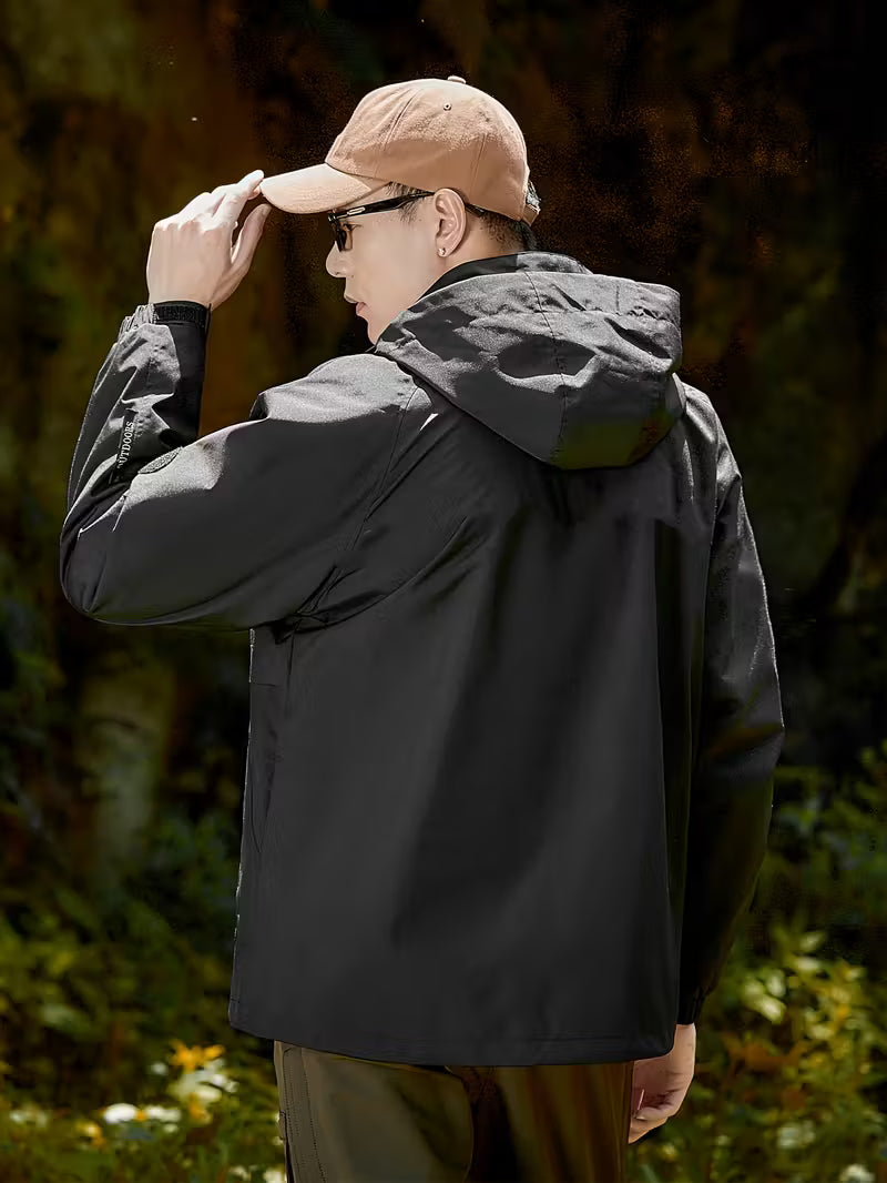 Person wearing a black jacket and beige cap in a forest setting