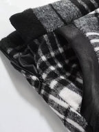 Close-up of a black and white patterned fabric with a zipper on a light gray background