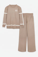 Beige sweatshirt and pants set with a logo on a white background