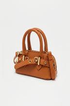 Brown handbag with silver hardware on a light gray background