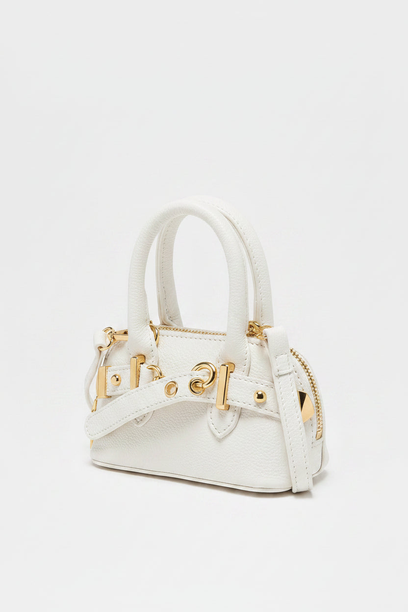 white handbag with silver hardware on a light gray background