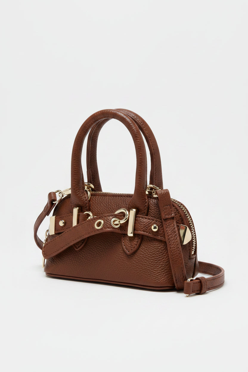 Brown handbag with silver hardware on a light gray background