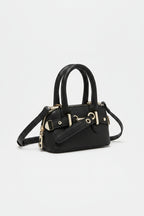 Brown handbag with silver hardware on a light gray background