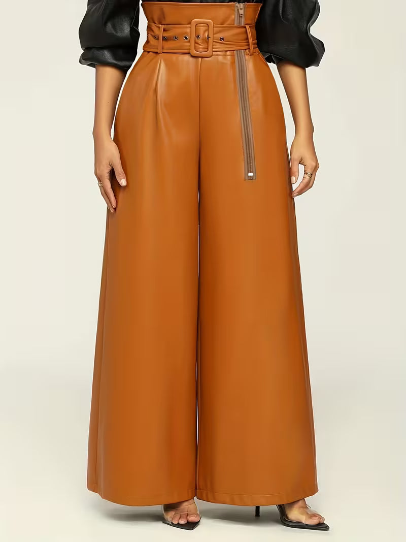 Brown leather pants with a belt on a neutral background