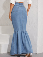 Blue denim skirt worn by a person on a light gray background