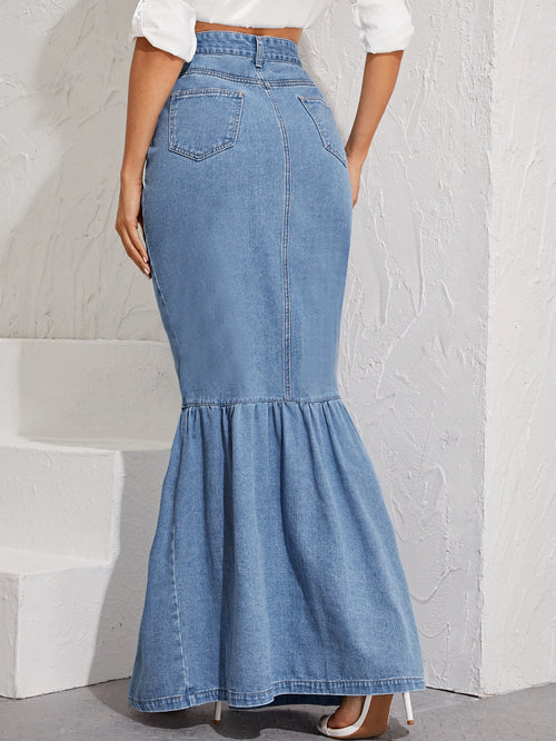Blue denim skirt worn by a person on a light gray background