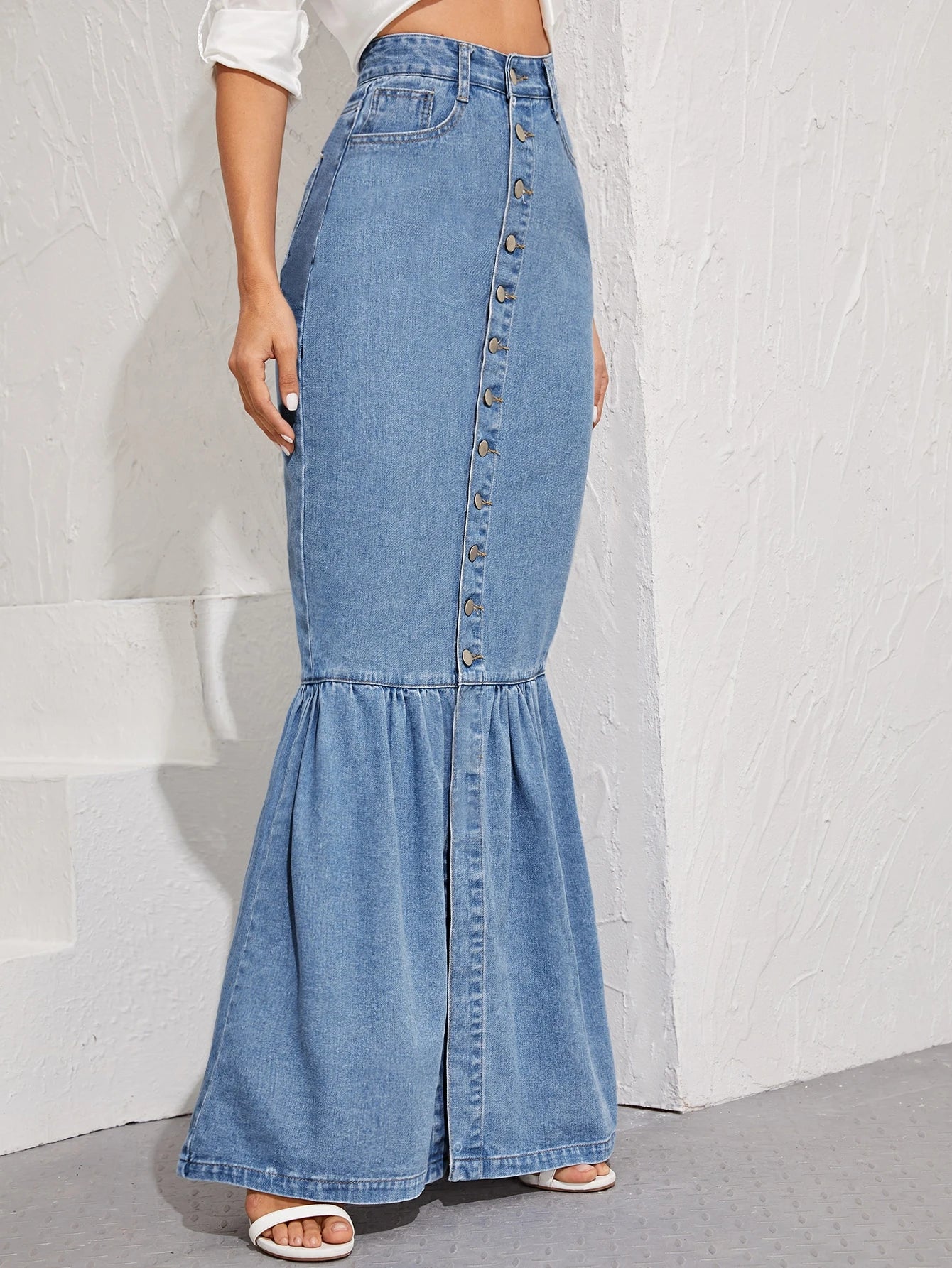 Denim skirt with button details on a white background