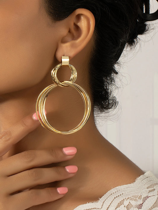 FAVEN Gold hoop earrings on a beige background