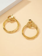 FAVEN Gold hoop earrings on a beige background
