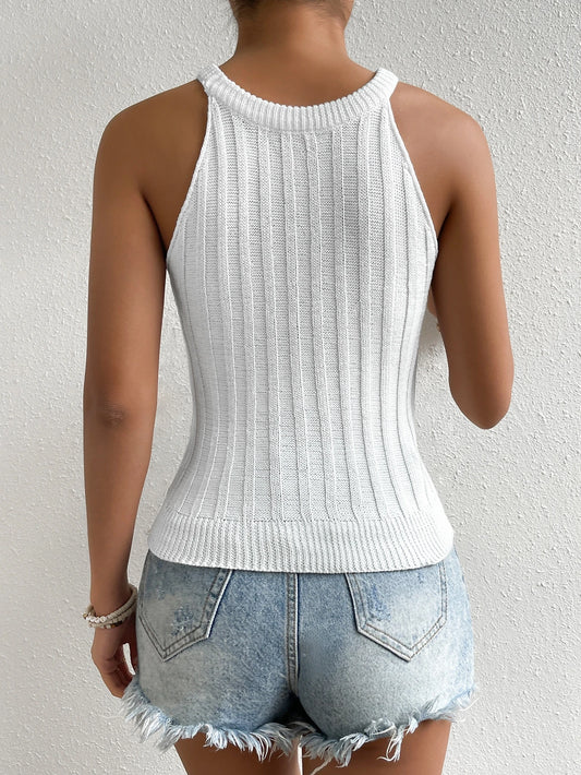 Person wearing a white ribbed tank top and denim shorts against a light gray background