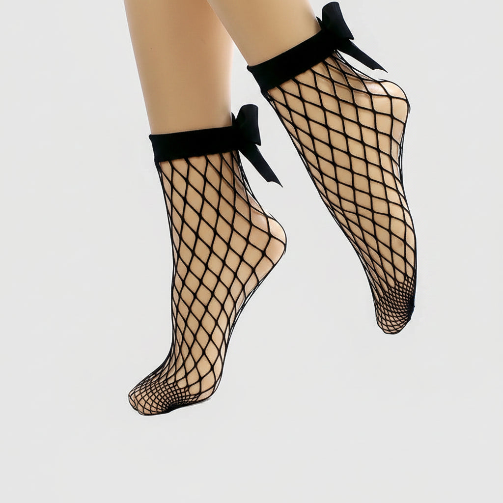 Black fishnet socks with bow details on a white background
