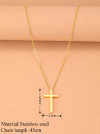 Gold cross necklace with measurements on a pink background