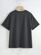 Black t-shirt on a hanger against a white background