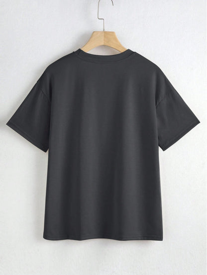 Black t-shirt on a hanger against a white background
