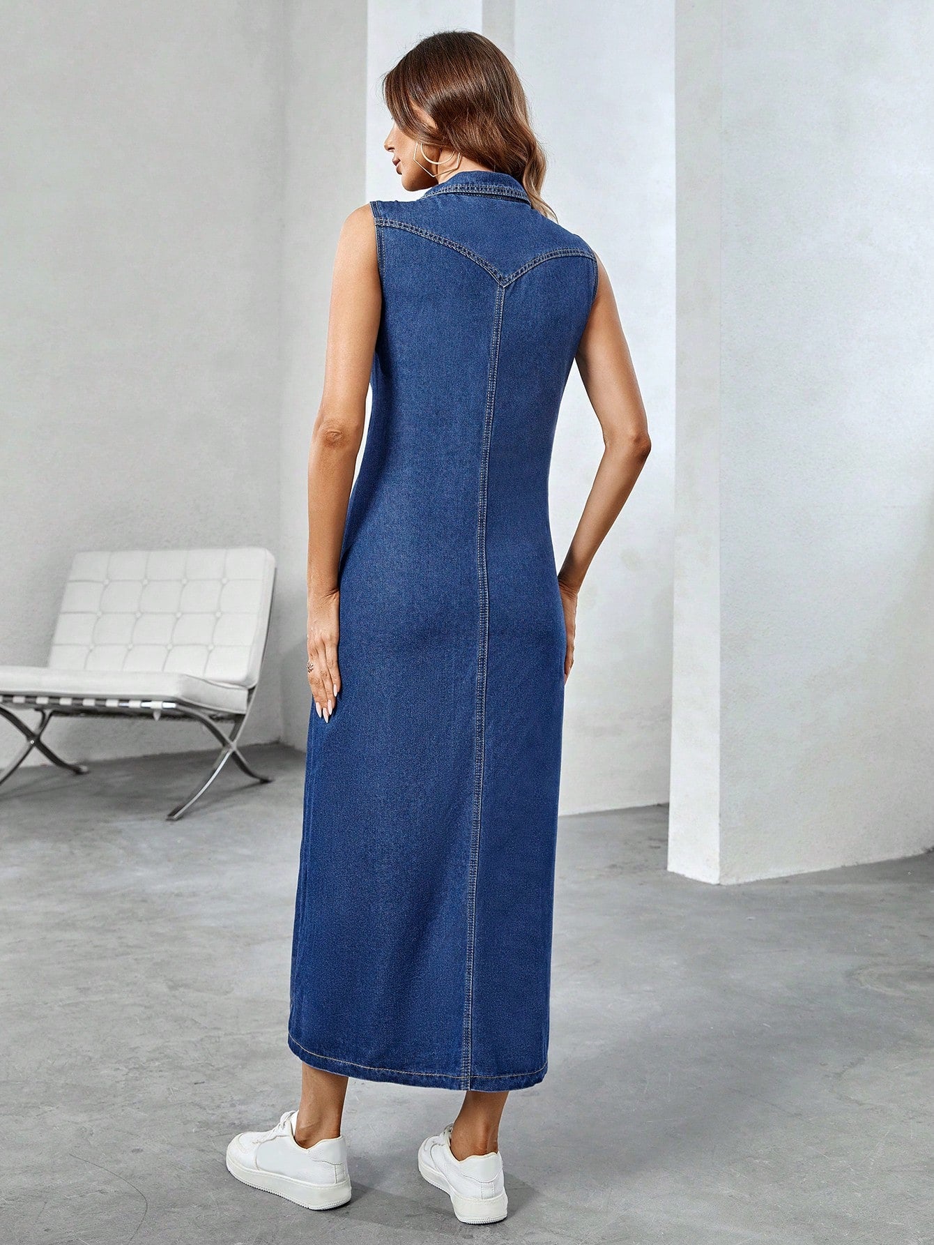 Woman wearing a blue denim dress in an indoor setting