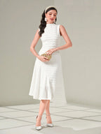 Woman wearing a white dress with a plain background