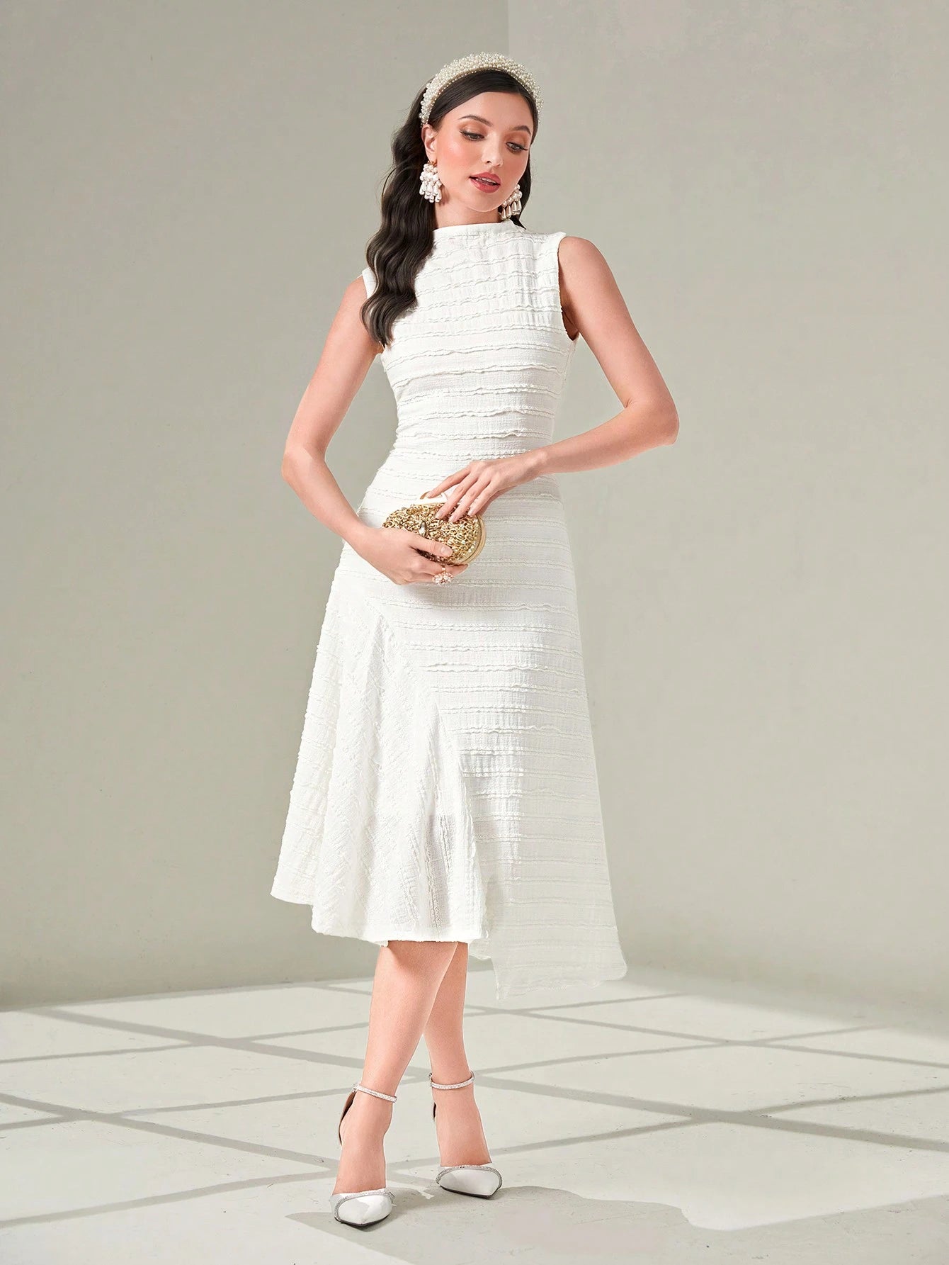 Woman wearing a white dress with a plain background