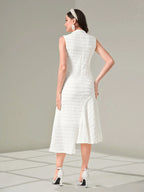 Woman wearing a white dress with a plain background