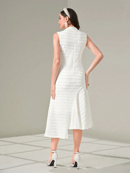 Woman wearing a white dress with a plain background