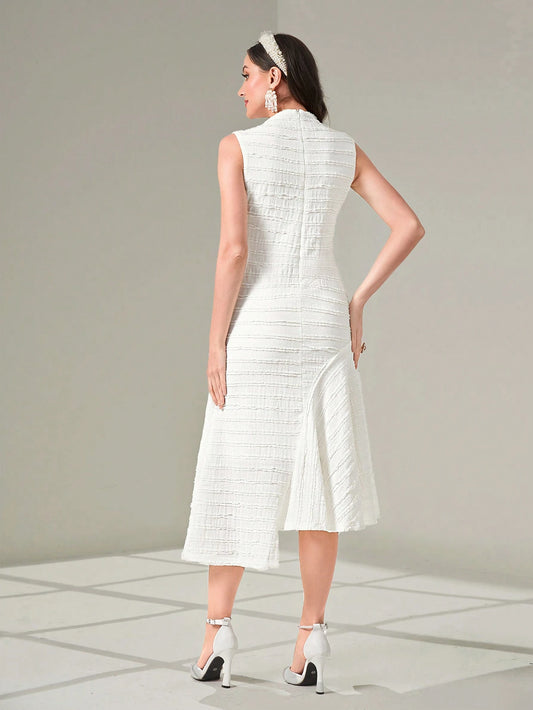Woman wearing a white dress with a plain background