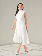 Woman wearing a white dress with a plain background