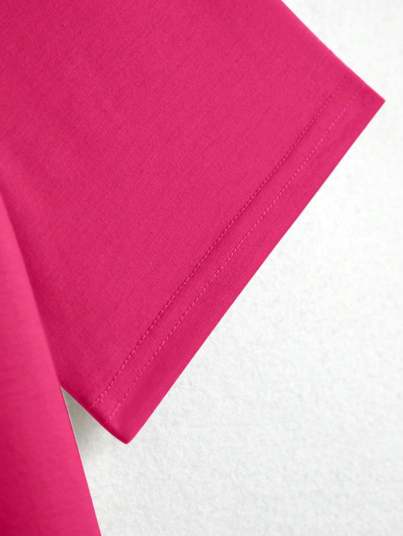 Close-up of a pink fabric corner on a white background
