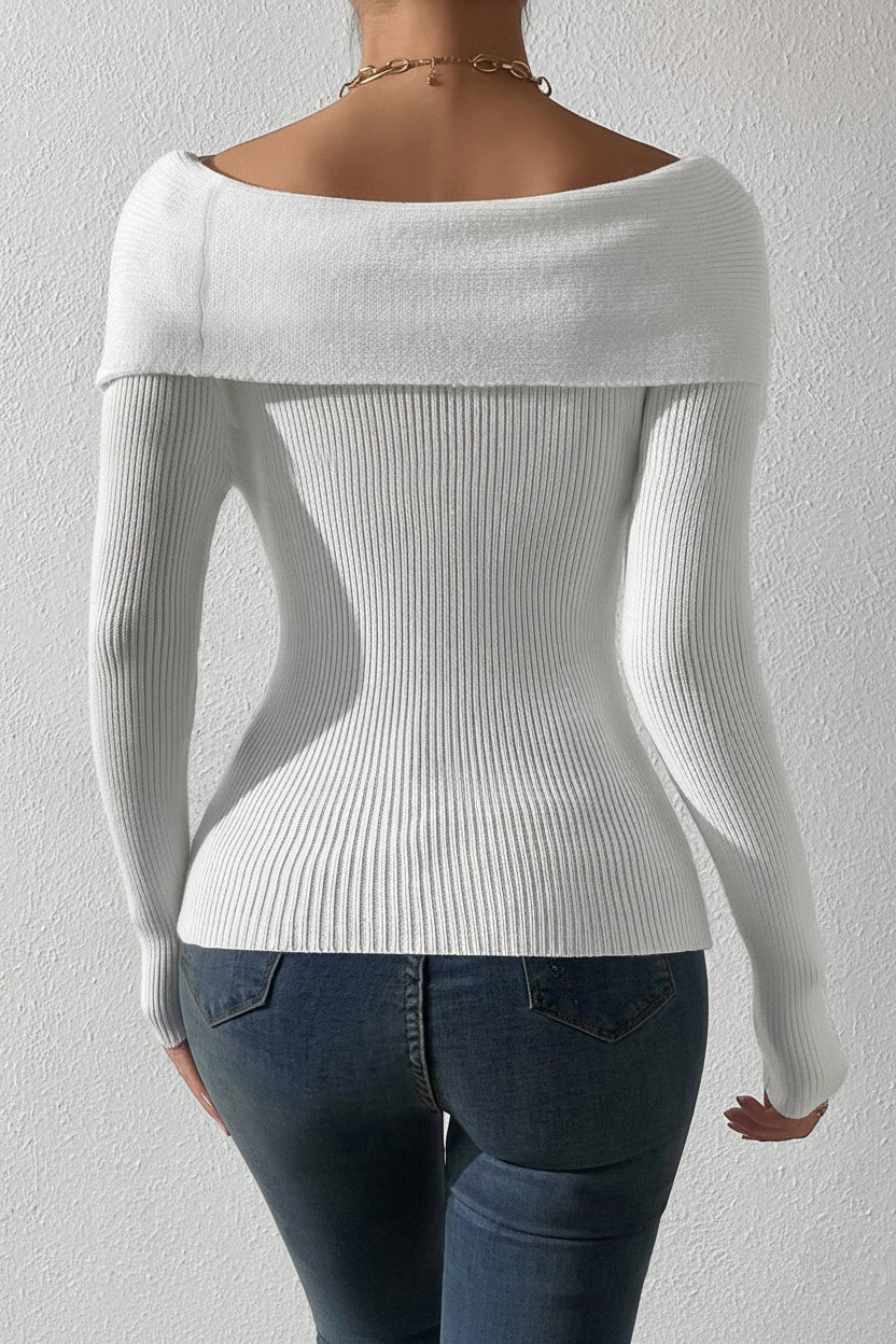 White off-shoulder sweater worn by a person against a plain background