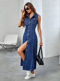 Woman wearing a blue denim dress with a slit, standing in a modern indoor setting.