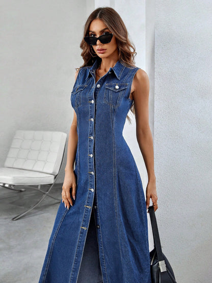 Woman wearing a long denim dress with sunglasses indoors.