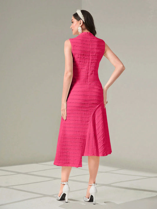 Woman wearing a pink dress with a textured pattern on a gray background
