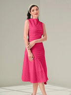 Woman wearing a pink dress against a light gray background