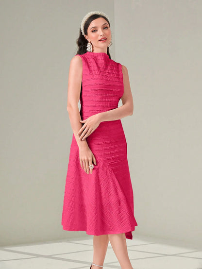 Woman wearing a pink dress against a light gray background