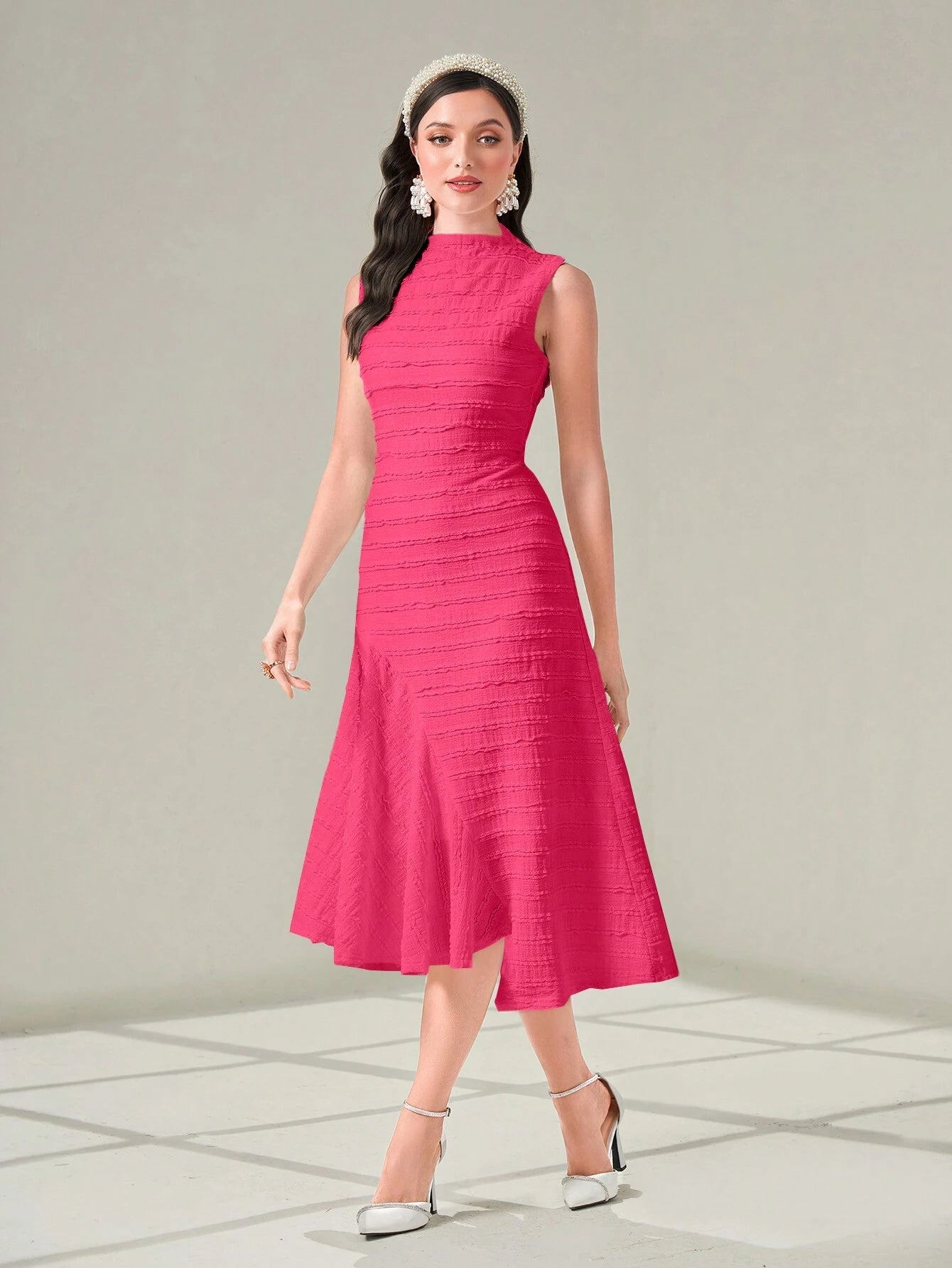 Woman wearing a pink dress with a white background