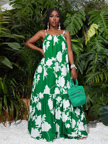 Woman in a green floral dress holding a green handbag amidst green plants.
