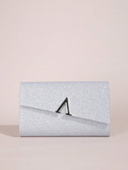 Silver glitter clutch bag with a black clasp on a beige background