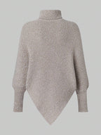 Knitted poncho on a light gray background