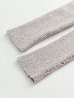 Two beige fabric swatches on a white background