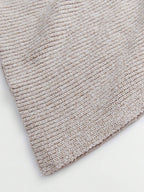Close-up of a textured beige rug on a white background