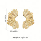 FAVEN Gold earrings worn by a person with a neutral background