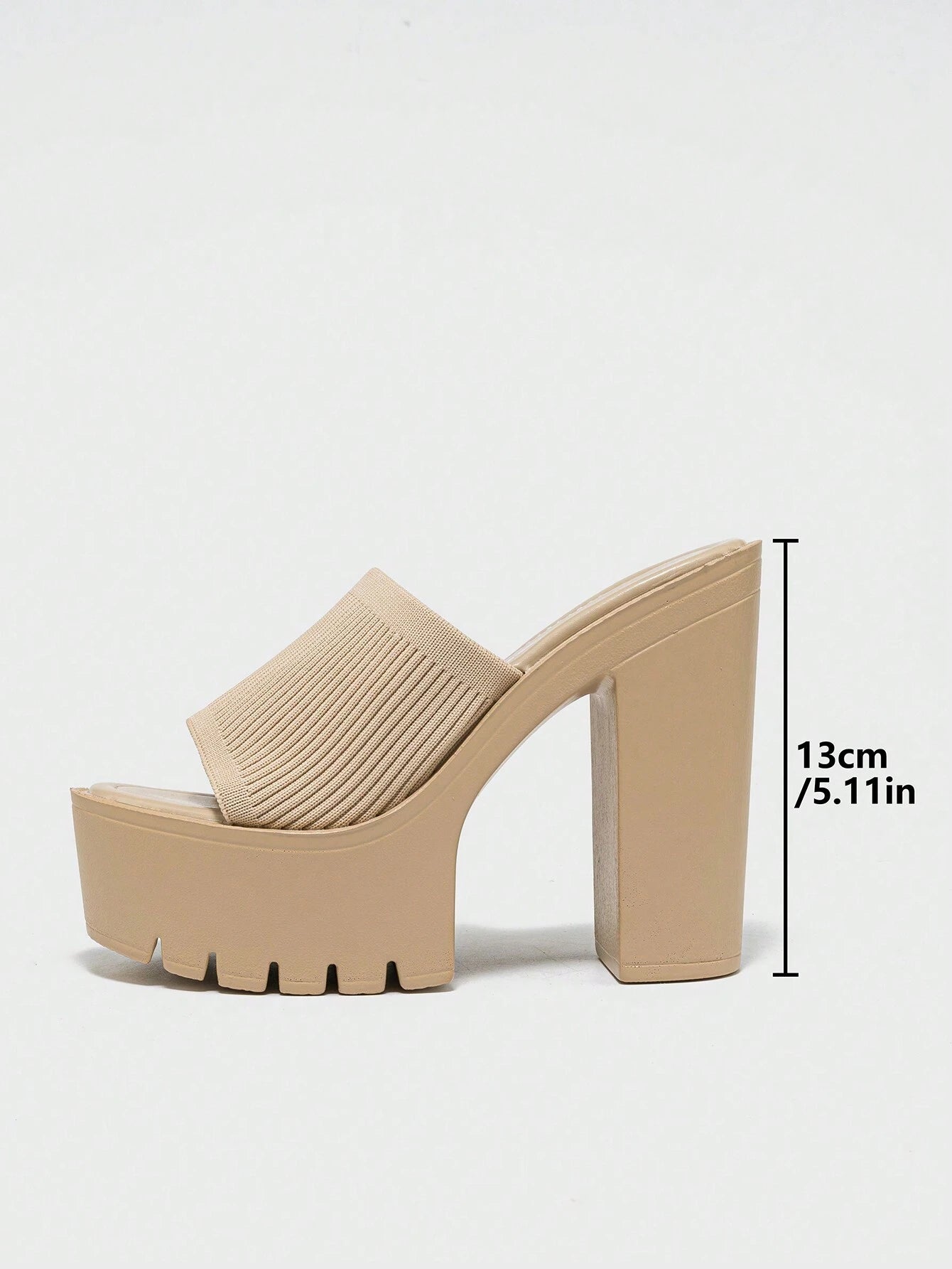 Beige high-heeled mule shoe with a measurement label on a white background