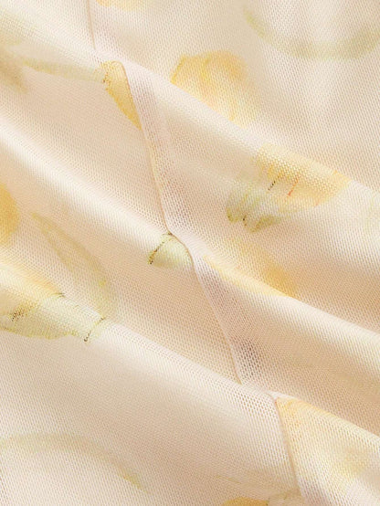 Close-up of a textured fabric with yellow accents on a light background