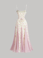 Long floral dress with pink and white pattern on a gray background
