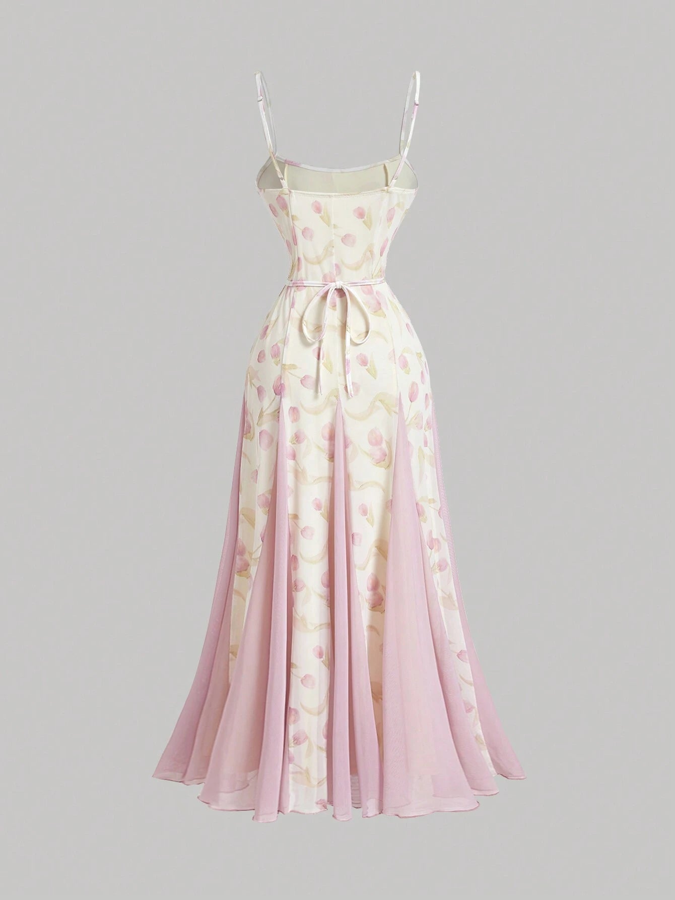 Long floral dress with pink and white pattern on a gray background