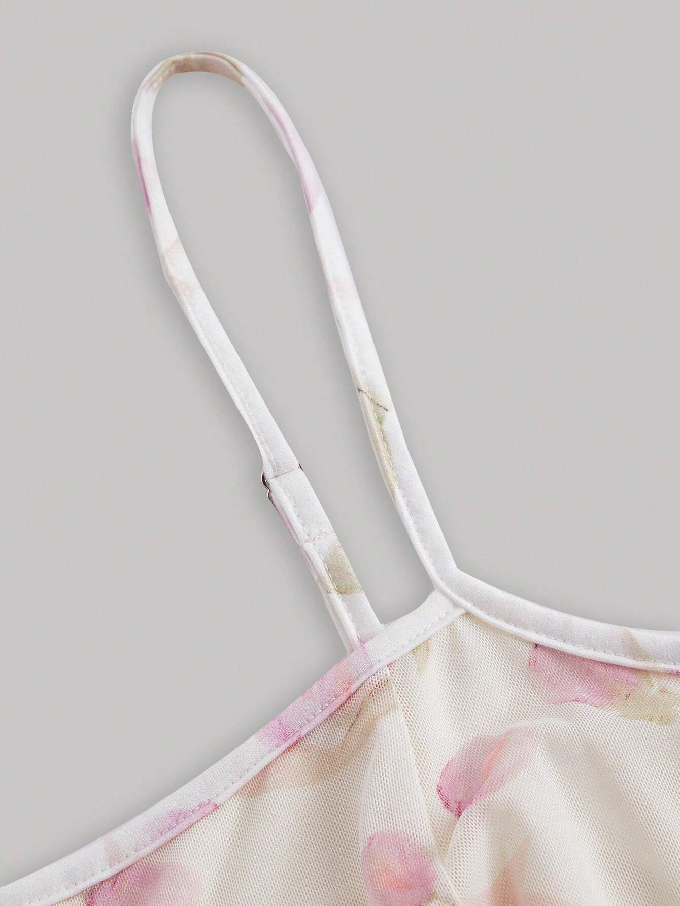 Close-up of a floral dress strap on a light gray background